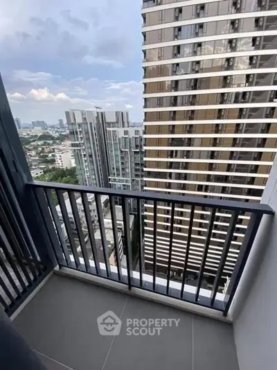 Modern high-rise balcony with cityscape view, perfect for urban living.
