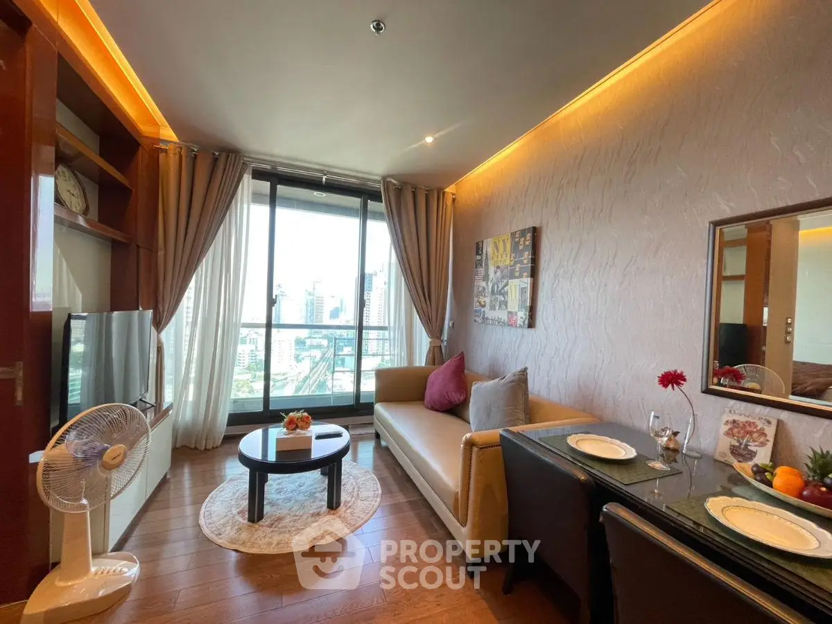 Stylish living room with city view, modern decor, and cozy seating area in a high-rise apartment.