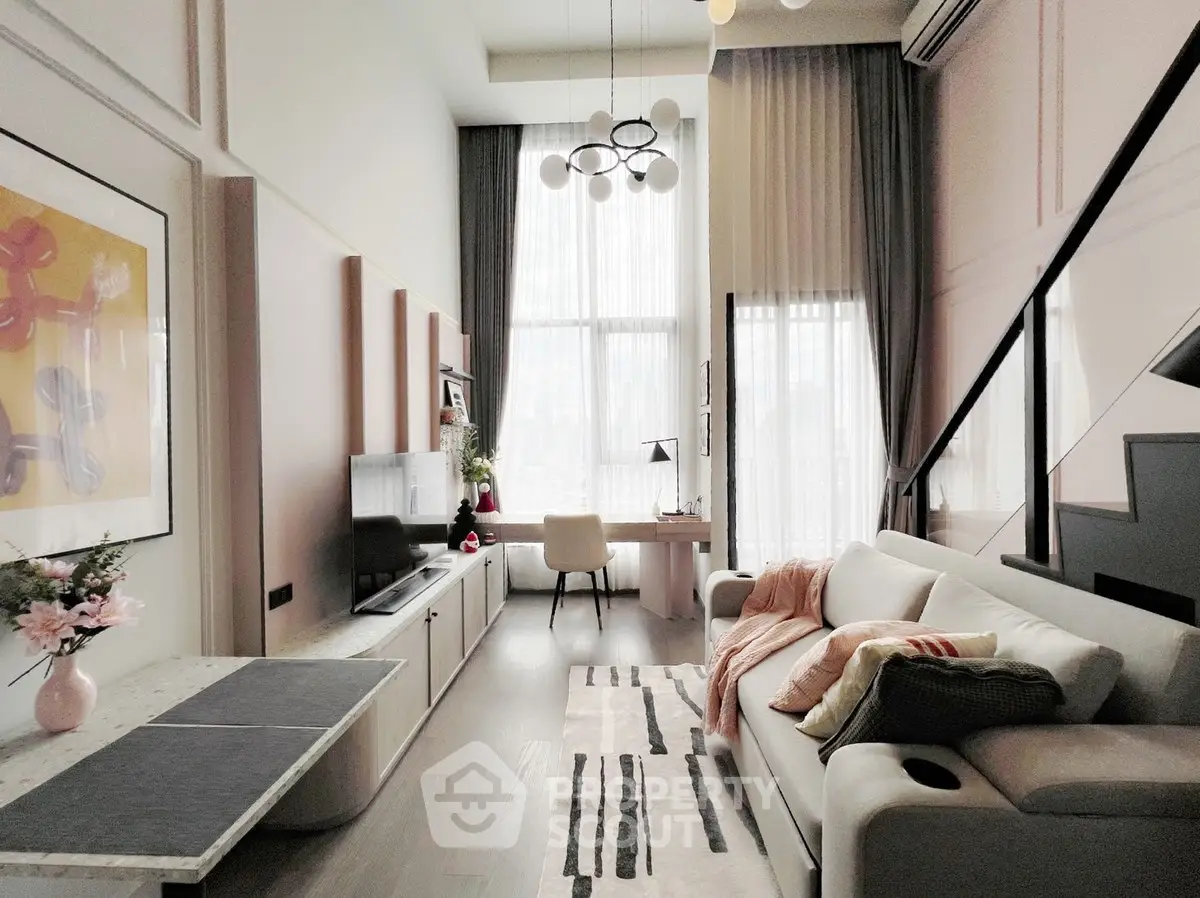 Modern living room with high ceilings, stylish decor, and natural light