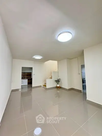 Spacious modern living room with sleek tile flooring and minimalist design