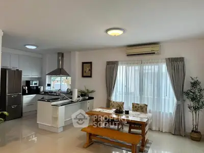 Spacious kitchen with dining area, featuring modern appliances and natural light, perfect for family gatherings.