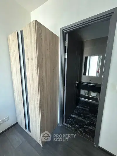 Modern apartment with sleek bathroom and stylish wardrobe, perfect for urban living.