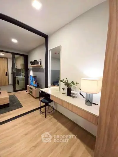 Modern apartment interior with stylish decor and open layout, featuring a cozy living area and sleek wooden flooring.