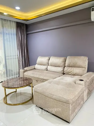 Luxurious modern living room with plush beige sectional sofa and elegant marble coffee table.