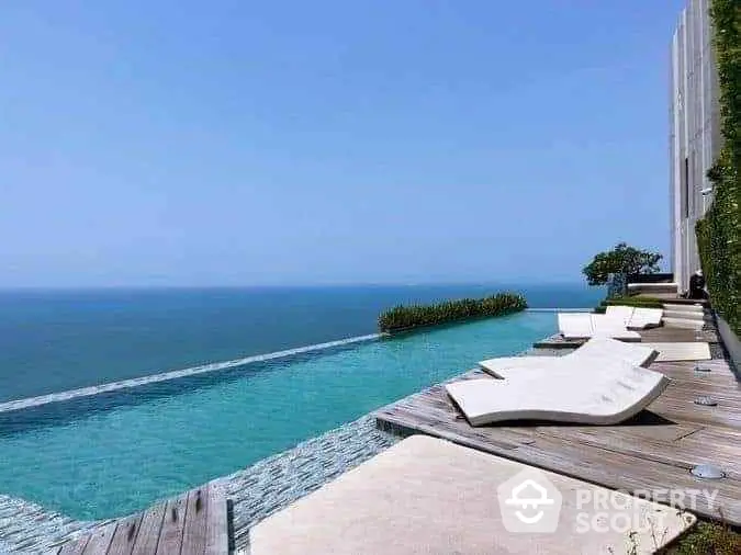 Luxurious infinity pool with stunning ocean view and modern lounge chairs