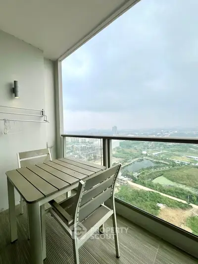 Stunning balcony with panoramic city view and modern outdoor furniture.