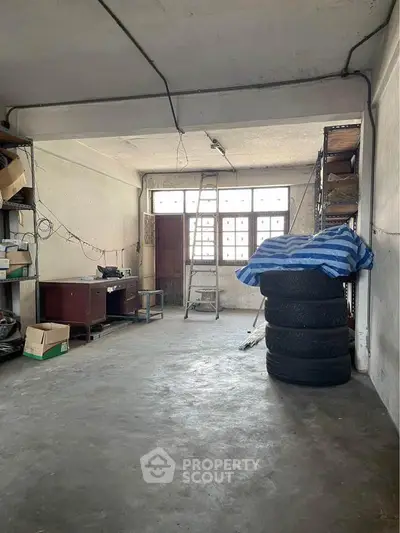 Spacious garage with ample storage and natural light, ideal for workshop or parking.