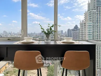 Stunning high-rise dining area with panoramic city views and elegant decor.