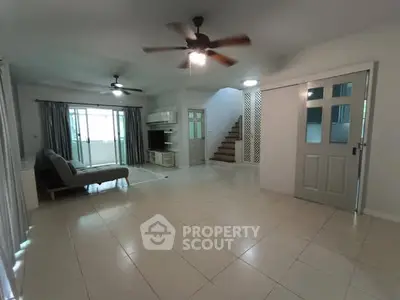 Spacious living room with ceiling fan and modern decor