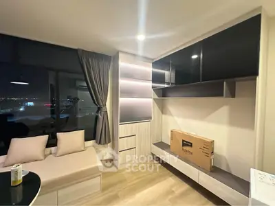 Modern living room with sleek furniture and city view at night