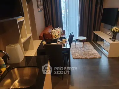 Modern living room with open kitchen, stylish decor, and city view balcony.