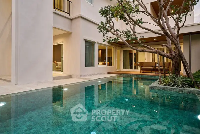 Luxurious modern home with stunning pool and elegant patio area, perfect for relaxation and entertainment.