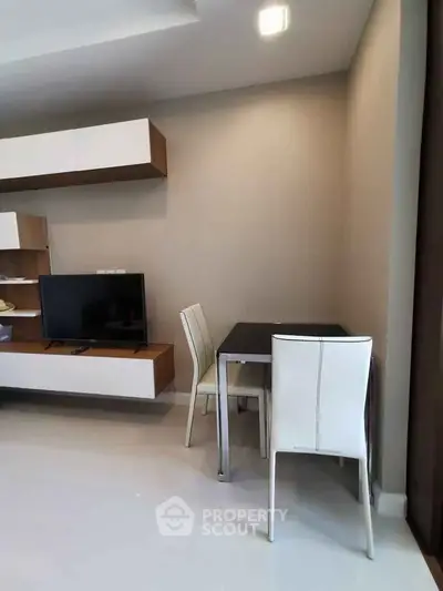 Modern living room with sleek furniture and wall-mounted TV unit