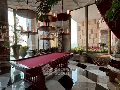 Luxurious indoor game room with elegant pool table and stylish decor, perfect for entertainment and relaxation.