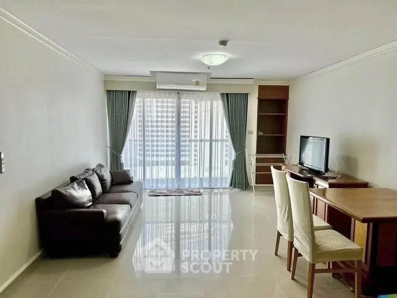 Spacious living room with modern furniture and large windows offering natural light.