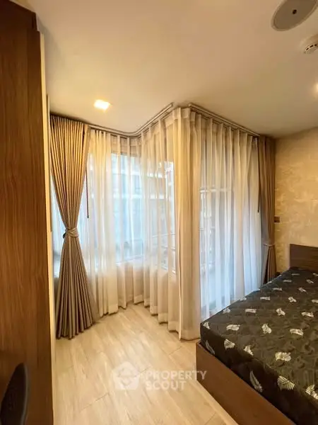 Cozy bedroom with elegant curtains and natural light