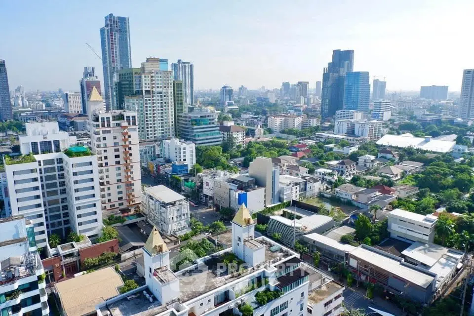 Stunning aerial view of urban skyline with modern high-rise buildings and lush greenery.