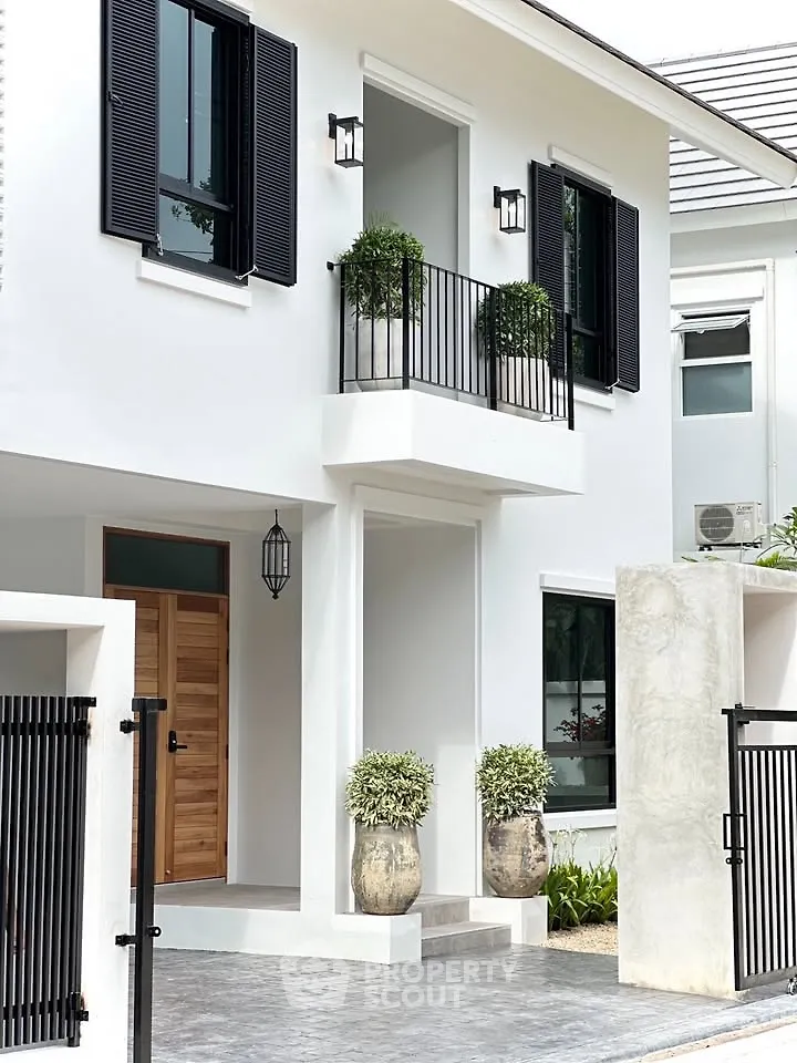 Elegant modern house exterior with stylish balcony and lush greenery
