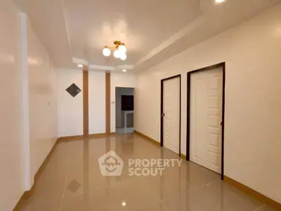 Spacious interior with glossy tiled floors and modern lighting