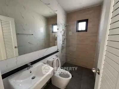 Modern bathroom with sleek fixtures and spacious shower area