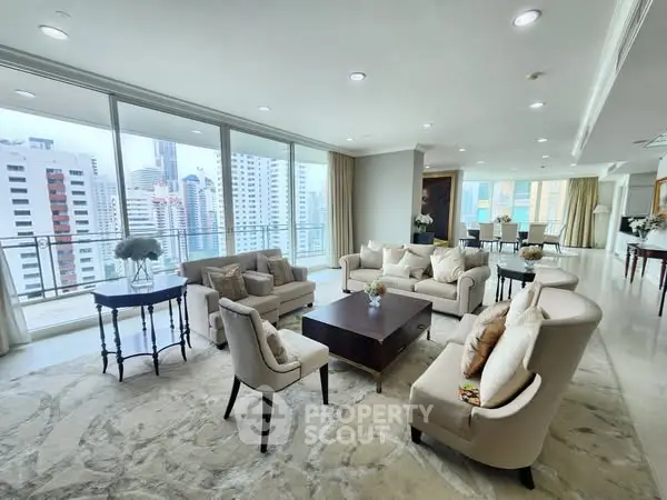 Luxurious living room with panoramic city views and elegant furniture in a high-rise apartment.
