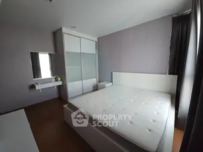 Spacious modern bedroom with sleek design and ample natural light