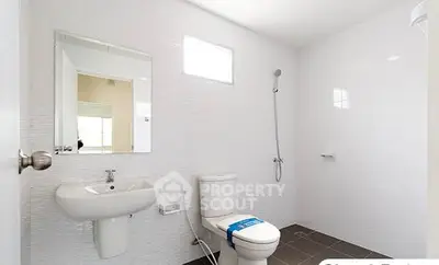 Modern minimalist bathroom with sleek fixtures and natural light.