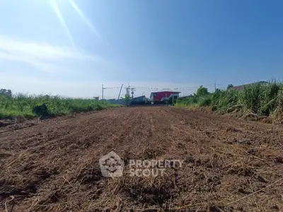 Expansive plot of land with clear blue sky, perfect for development opportunities.