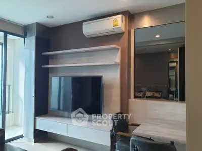 Modern living room with sleek TV setup and air conditioning, perfect for relaxation.