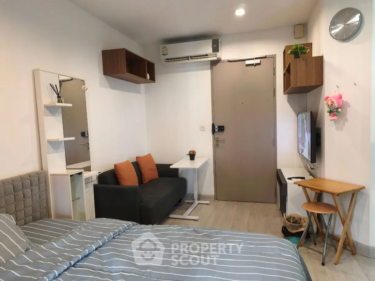 Modern studio apartment with cozy living area and stylish decor