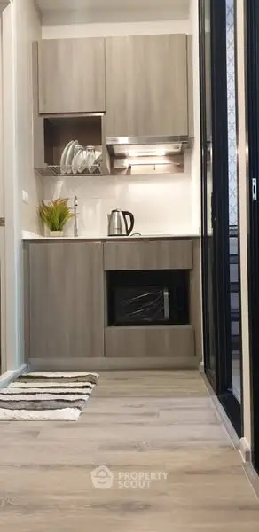 Modern compact kitchen with sleek cabinetry and stainless steel appliances
