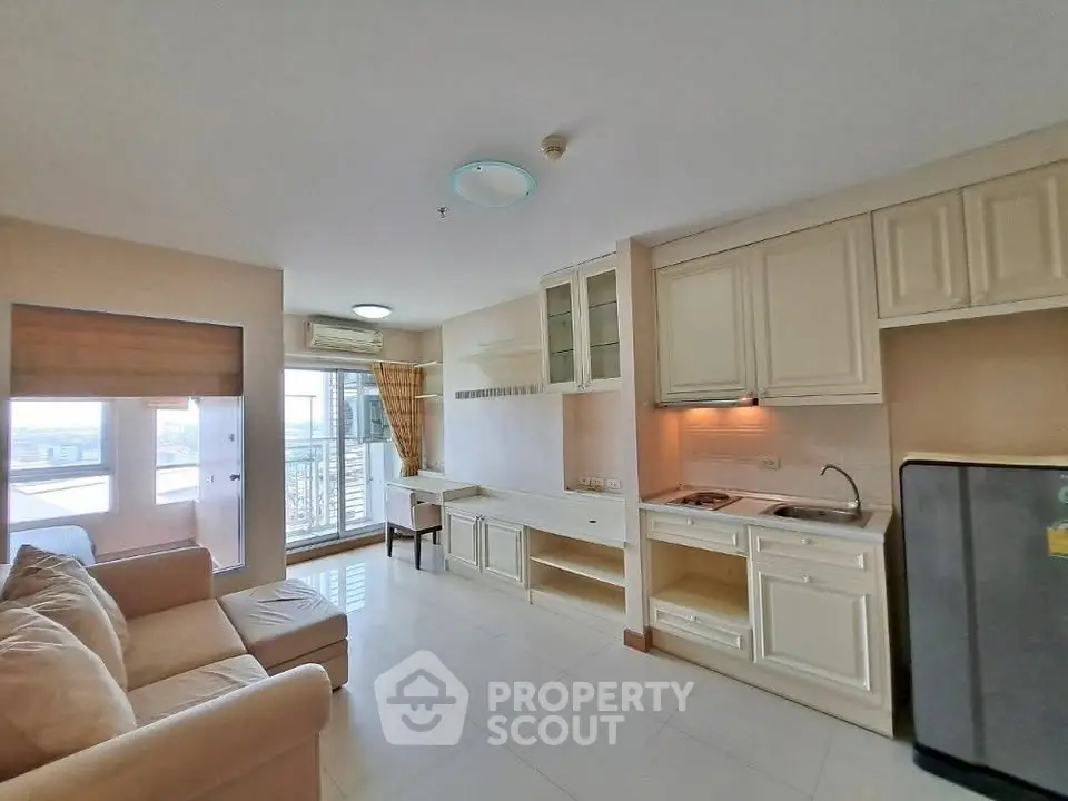 Spacious open-layout living room with modern kitchen and city view balcony.