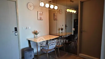 Stylish dining area with modern lighting and elegant decor in a contemporary apartment.