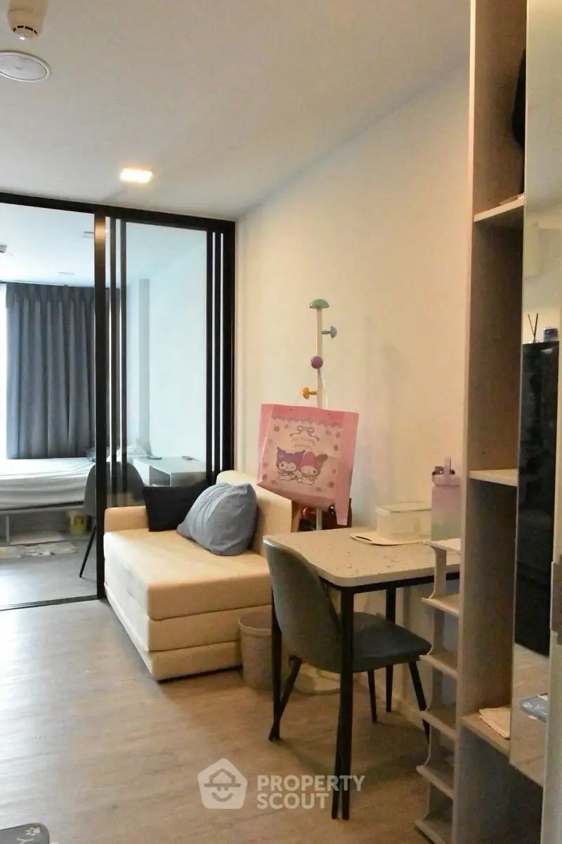 Modern living room with cozy sofa and stylish decor in open layout apartment.