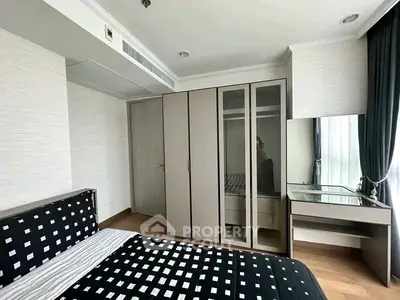 Modern bedroom with stylish decor and ample storage in a contemporary apartment.