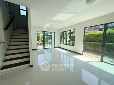 Spacious modern living room with large windows and garden view