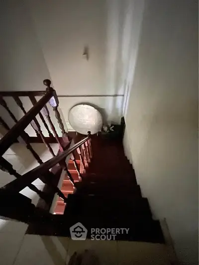 Cozy staircase with wooden railing in a charming home interior