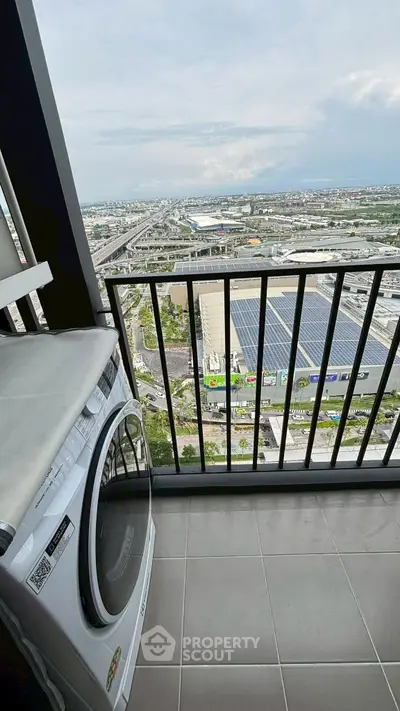 Stunning high-rise balcony view with modern washing machine and expansive cityscape.