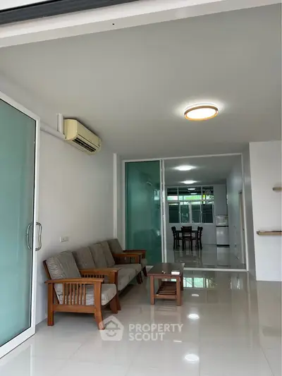 Spacious modern living room with sleek furniture and open layout, perfect for contemporary living.