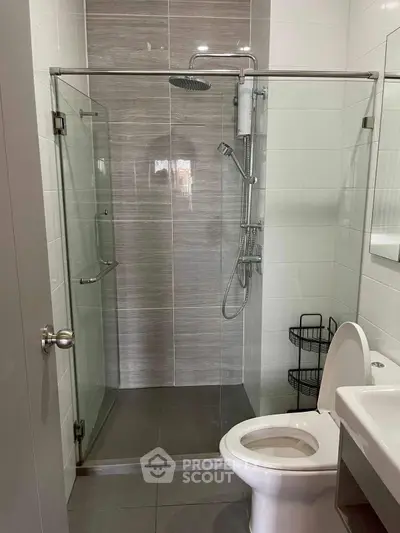 Modern bathroom with glass shower enclosure and sleek fixtures