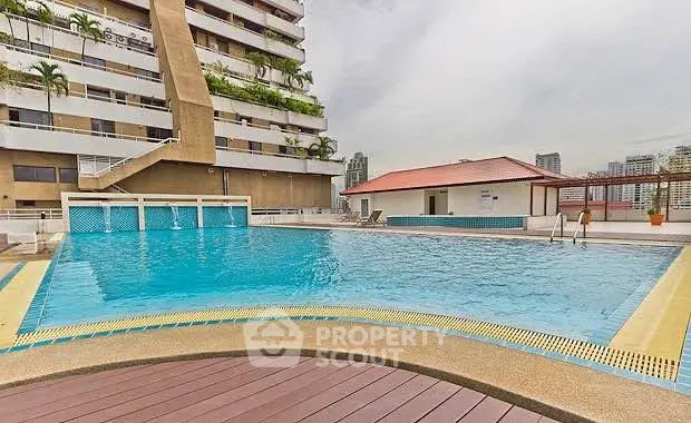 Luxurious rooftop pool with city views in a modern residential building.