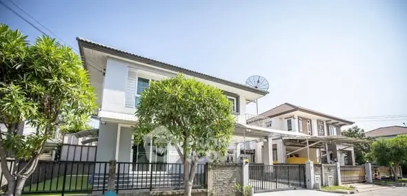 Modern two-story house with lush greenery and spacious driveway