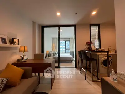 Modern open-plan living room with kitchen and bedroom in a stylish apartment