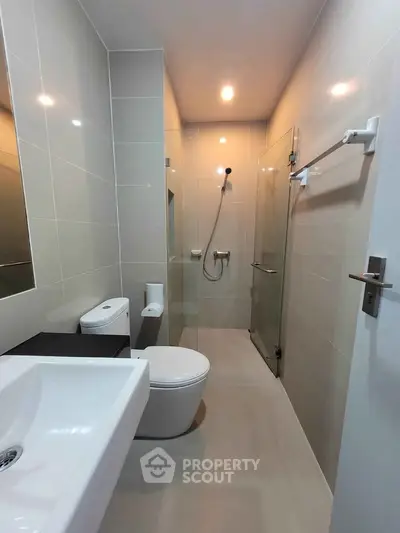 Modern bathroom with sleek fixtures and glass shower enclosure