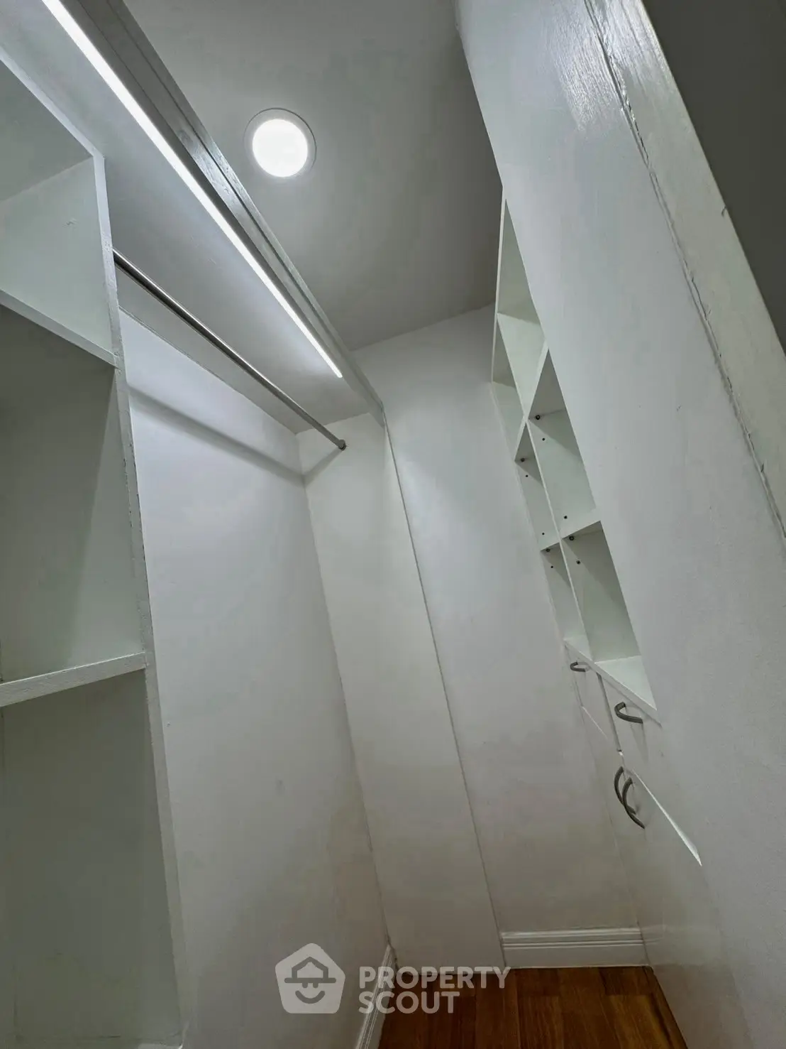 Spacious walk-in closet with ample shelving and hanging space, perfect for organized storage in a modern home.