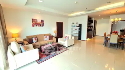 Spacious and elegant living room with modern decor and dining area, perfect for family gatherings.