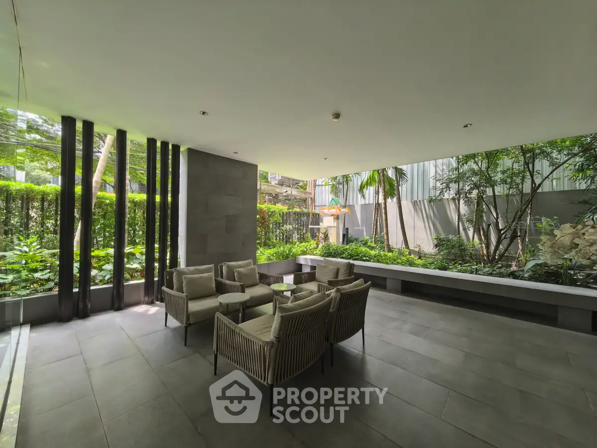 Modern outdoor seating area with lush garden view in luxury property