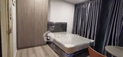 Modern bedroom with sleek wardrobe and bed, featuring elegant curtains and stylish flooring.