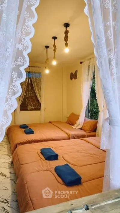 Cozy bedroom with twin beds and elegant lace curtains