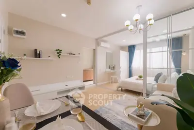 Modern open-plan living room and bedroom with elegant decor and natural light.